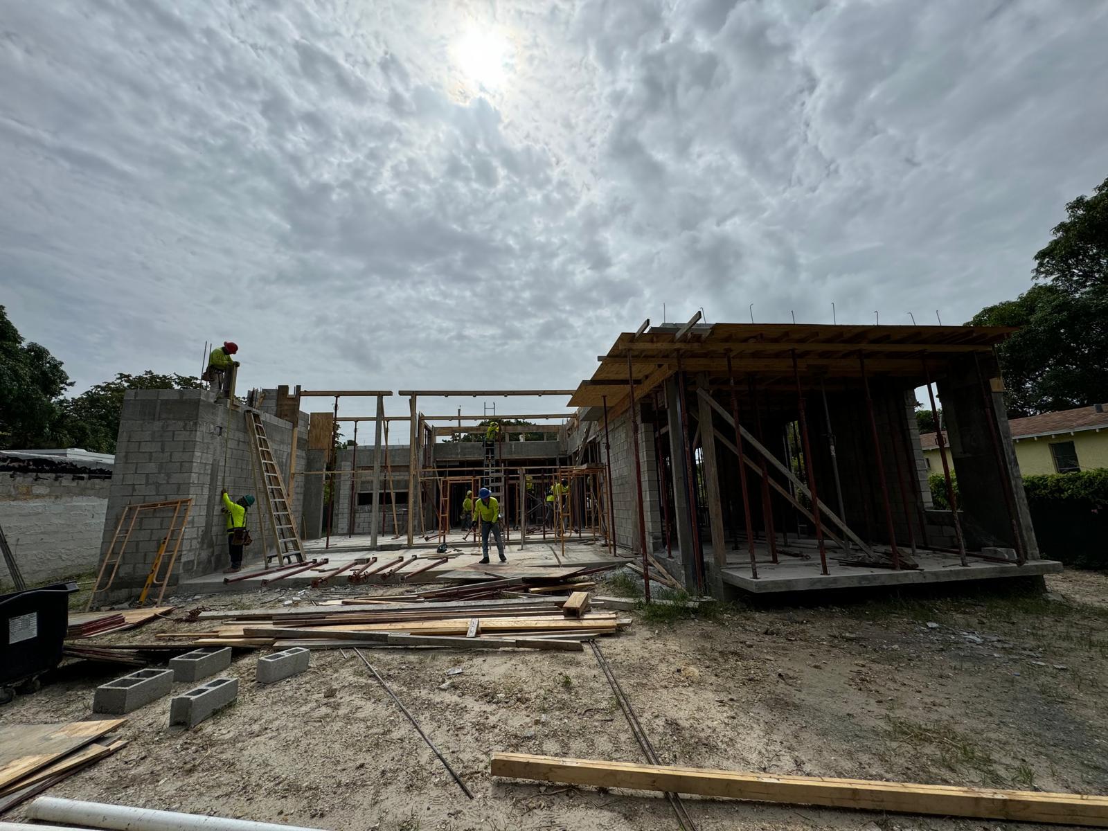 Workers building a concrete masonry residence